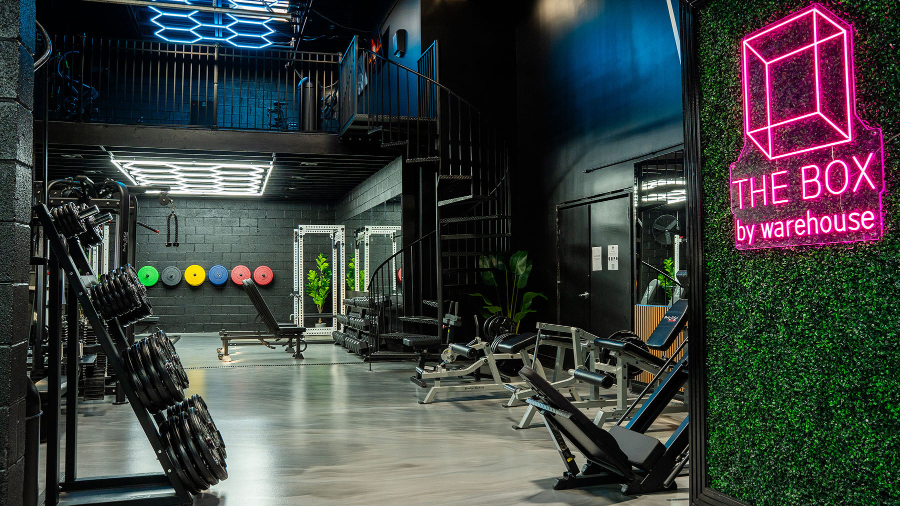 Interior of a gym with equipment and 'The Box by Warehouse' sign.
